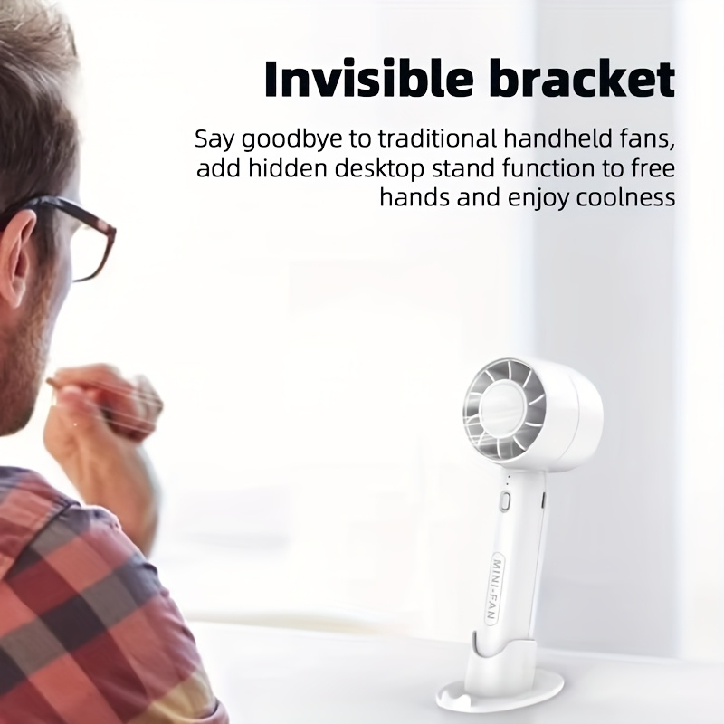 New mini handheld fan, USB rechargeable, comes with a stand for holding your phone.