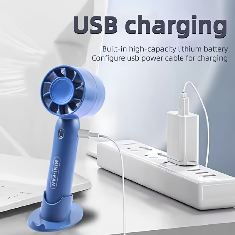 New mini handheld fan, USB rechargeable, comes with a stand for holding your phone.