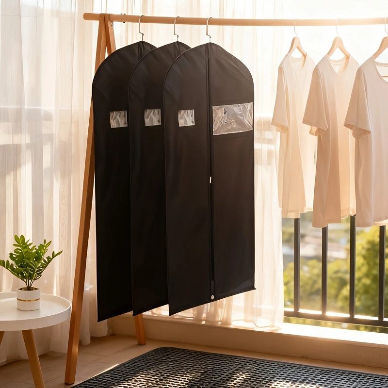 Black non-woven garment storage and dust cover; hanging suit organizer bag with a clear viewing window; easy-to-maintain, moisture-proof, and dust-proof storage bag for formal wear and suits.
