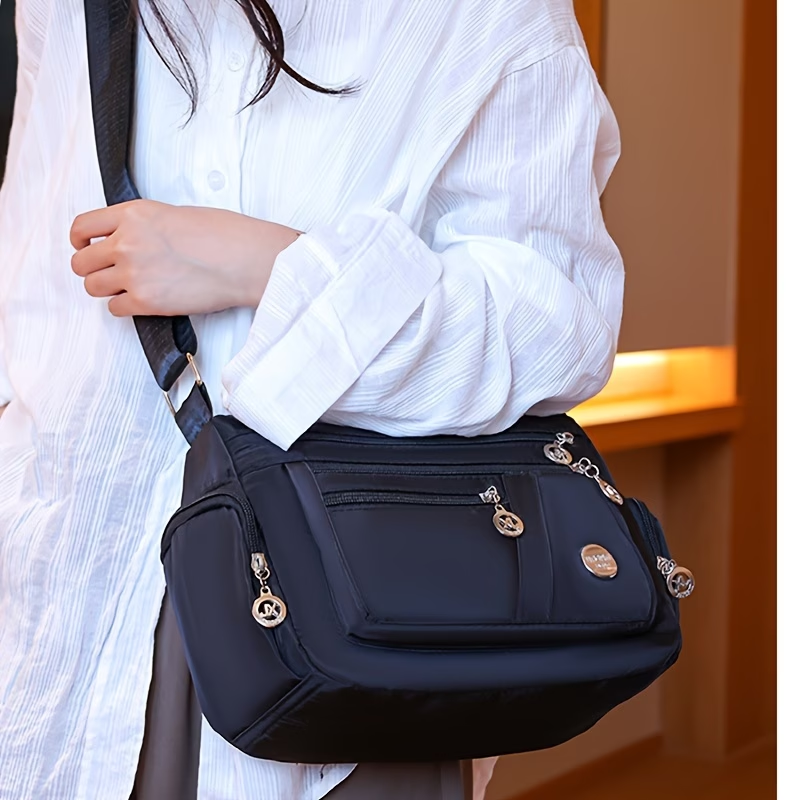 Unisex Casual Crossbody Bag - a Spacious Multi-Pocket Shoulder Bag with Adjustable Straps, Made from Lightweight And Durable Lining. The Black Version Features Tassel Details