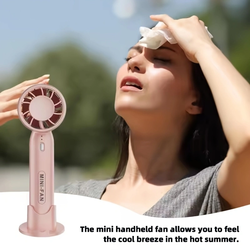 New mini handheld fan, USB rechargeable, comes with a stand for holding your phone.